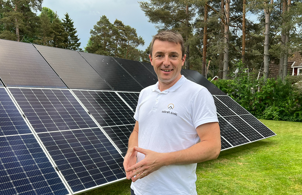 En man som står framför solceller.